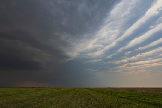 Supercell storm with herringbone clouds over green field in Tornado