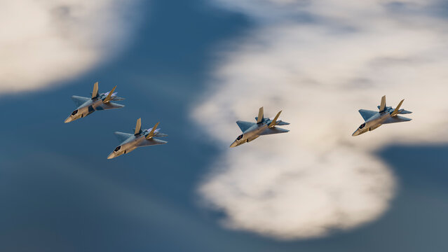 Four fighter jets flying in formation over clouds