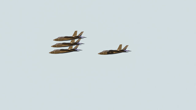 Fighter jets flying in formation against blue sky