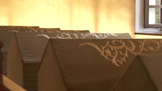 Cloth covered caskets rest within sacred worship room, devotional interior linked to burial.