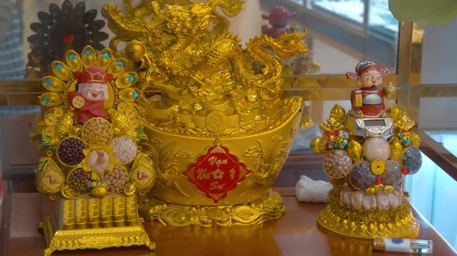 These Feng Shui ornaments are designed to attract wealth and prosperity, featuring a golden "treasure basin" filled with coins and a dragon figure on top is often referred to as a Chinese Gold Ingot 