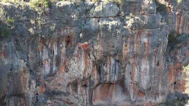 Large karst sinkhole reveals rocky walls deep depression with limestone geology rugged terrain.