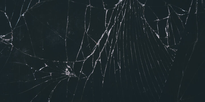 Severely cracked and broken black glass texture background