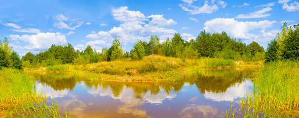 small calm lake among the forest  under a cloudy sky at the bright day © Yuriy Kulik