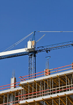 Tower crane works with formwork on construction