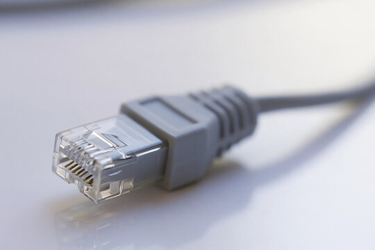 Macro of an rj45 connector on a grey network cable, wired connection close up
