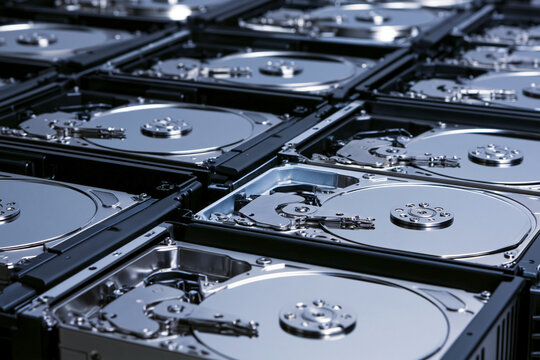 Rows of hard drives seated in a storage array, data capacity and backup concept