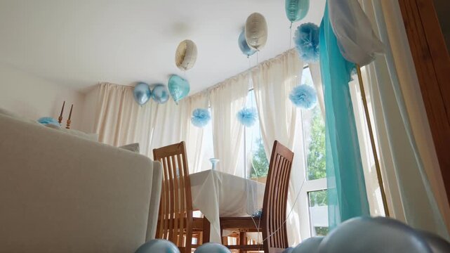 Birthday party room decorated with balloons low angle camera movement