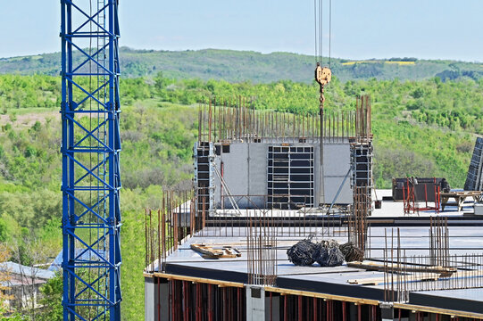 Vertical formwork, reinforcement and crane on construction