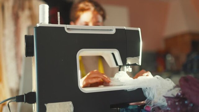 Sewing fabric at home in a craft room during the day with a sewing machine and various tools on the table