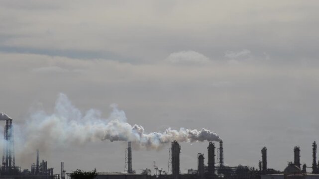 Air Pollution Concept - Industrial factory smokestacks billowing heavy smoke with sky background 4k Video footage