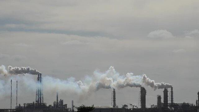 Air Pollution Concept - Industrial factory smokestacks billowing heavy smoke with sky background 4k Video footage