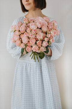 Portrait of brunette model with fresh rose flowers