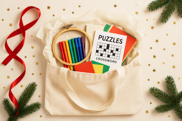Christmas gift bag with puzzles and markers on festive background © dvoevnore