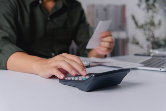 Hand Using Calculator for Financial Analysis Workflow