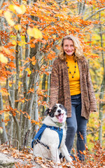 Fototapeta premium happy woman with dogs playing outdoors in autumn forest