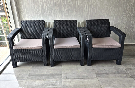 Synthetic rattan furniture set. Close-up of armchairs in an interior setting.