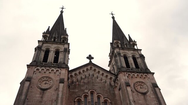 Historic stone church towers and facade in Cangas de Onis Spain