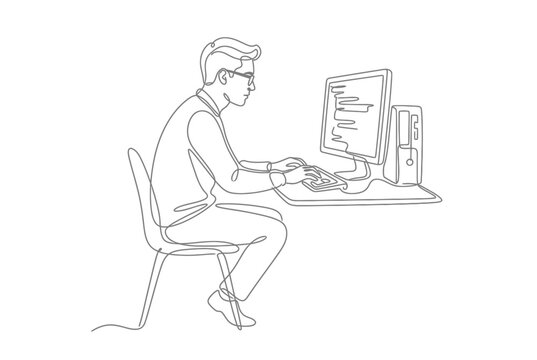 Computer programmer working on desktop PC at office desk.