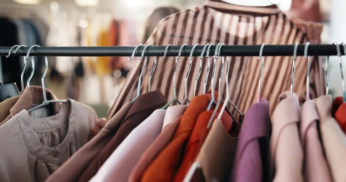 Boutique, decision and woman at clothes rack for shopping, outfit search or garment option on sale. Hanger, customer or browsing rail in store for fashion choice, retail promotion and wardrobe update