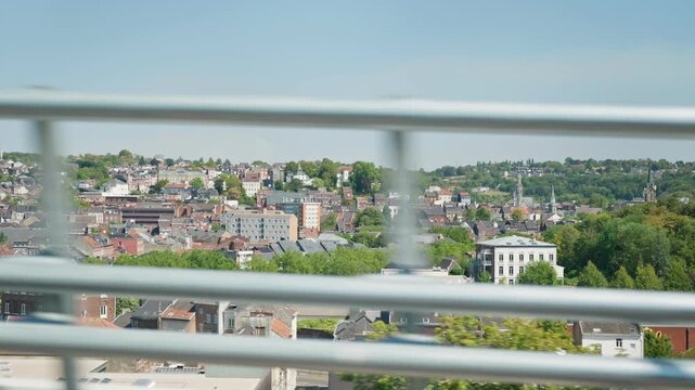 Cityscape viewed through a bridge railing motion blur