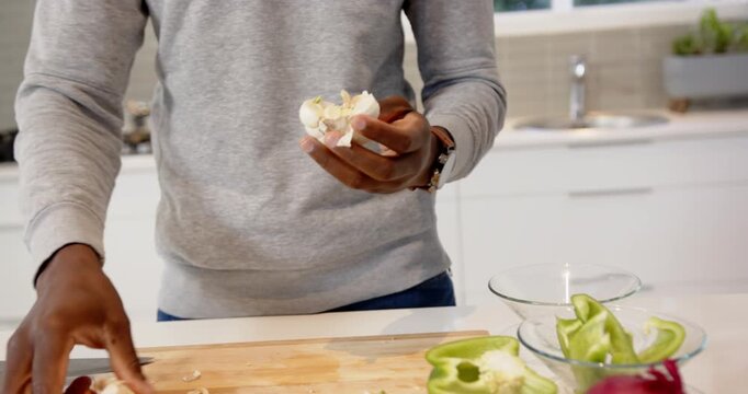 Lifestyle videos indoor of people doing activities at home, chopping garlic on board, person prepari