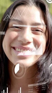 Vertical video: Teen squinting from sun, smiling with AR graphs overlaying face, testing face tech