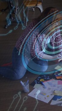 Vertical video: Designer kneeling on floor arranging notes and markers, activating HUD for planning