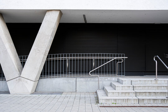 Modern concrete architecture with supports, stairs and railings in Nordbahnviertel, Vienna, Austria, where geometric concrete architecture frames the scene