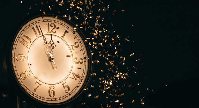 Vintage clock with gold confetti on black background, New Year celebration