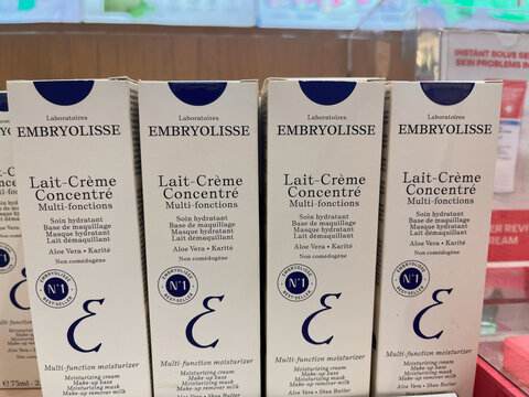 Four neatly arranged boxes of Lait-Cr&egrave;me Concentr&eacute; by Embryolisse. The packaging features a white background with blue text. The product is known for its moisturizing properties.