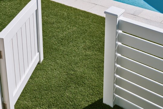 White slatted fence gate opens onto a lush green lawn and pool
