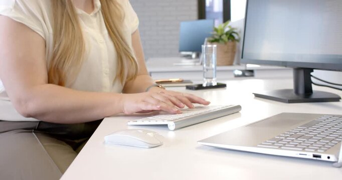 Lifestyle videos indoor of people doing activities at office, typing on keyboard, woman working at d