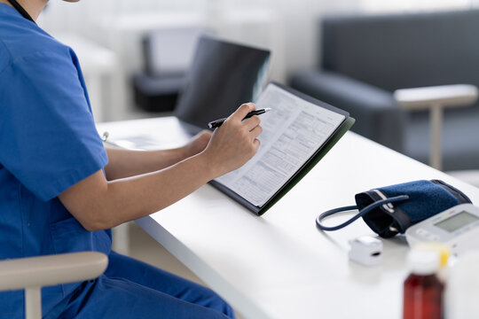 Doctor examines medical reports and patient data in clinic room