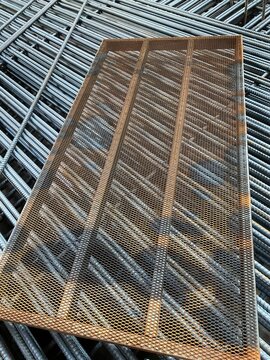 Steel reinforcement and temporary supports at an urban construction site in Silom, Bangkok, Thailand.