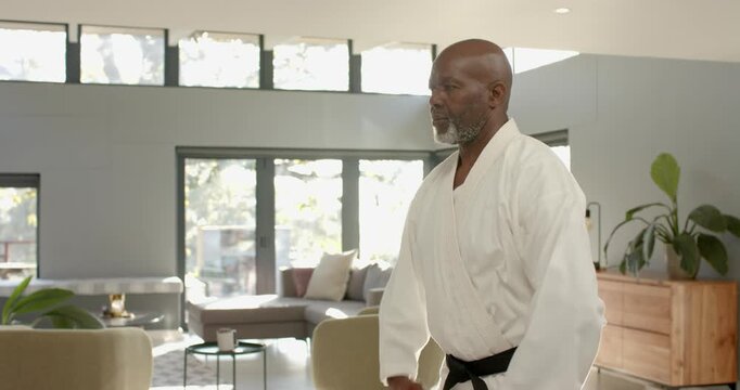 Lifestyle videos indoor of people doing activities at home, practicing martial arts, man in white ka