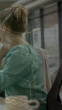 Vertical video: Business woman responding to colleague prompt, leaning and studying HUD maps charts