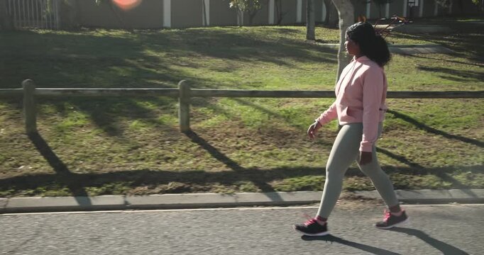 Lifestyle videos outdoor of people doing activities, walking on sidewalk, woman in athletic wear exe