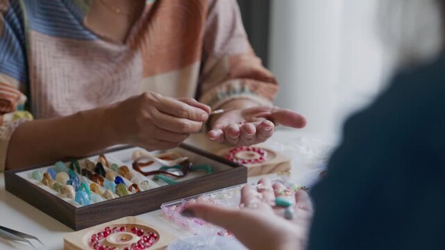 asian people making stringing beads in workshop creative craft  indoor