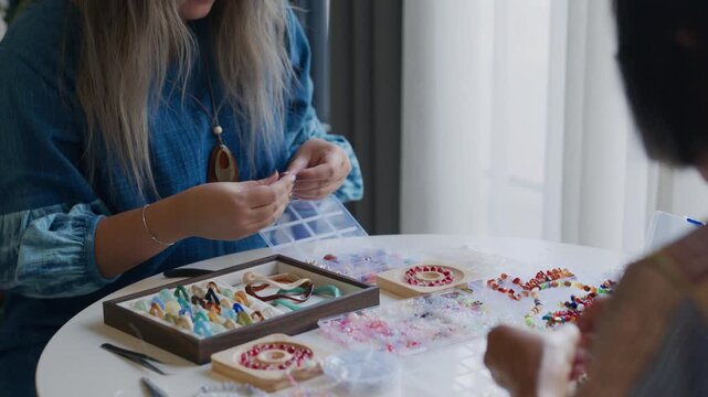 asian people making stringing beads in workshop creative craft  indoor