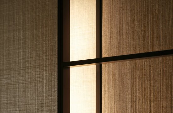 Soft light filters through textured fabric panels, creating a warm, serene interior ambiance
