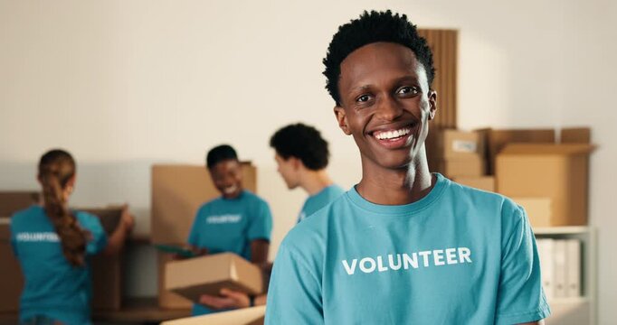 Happy man, volunteer and face in NGO with pride, community service and outreach program. Coordinator, confident and laugh at centre for food drive, social responsibility or philanthropic about us