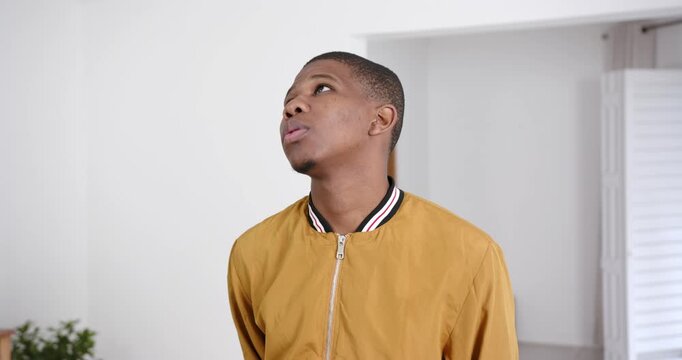 High speed photography for dynamic scenes, Looking away, man in yellow jacket standing indoors, appe