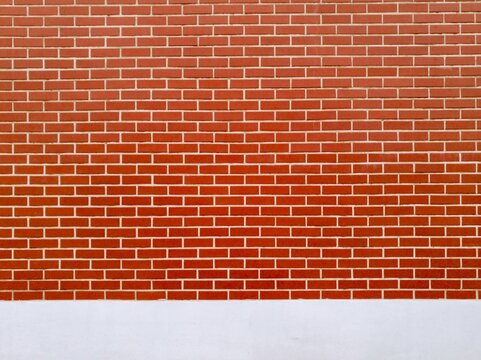 Red brick wall texture background with white plaster base and clean masonry brickwork pattern for architectural design.
