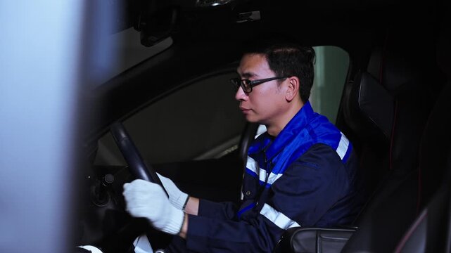 Automotive Technician Inspecting Vehicle Interior and Electrical Components During Car Repair. Automotive technician working inside a vehicle while inspecting electrical and mechanical components, rep