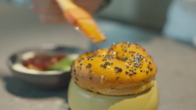 Food Preparation brushing a bun with egg nog