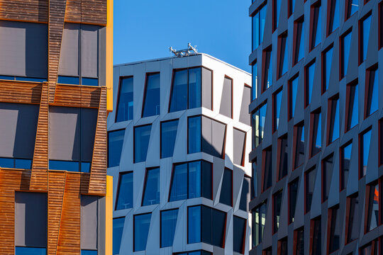 Contemporary buildings with varied facades and windows, showing modern urban architecture through colorful geometric residential buildings and facades