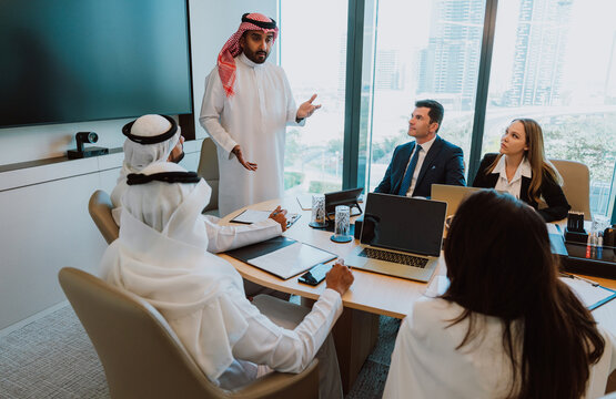 Arab saudi businessman leading meeting and discussing strategy with team
