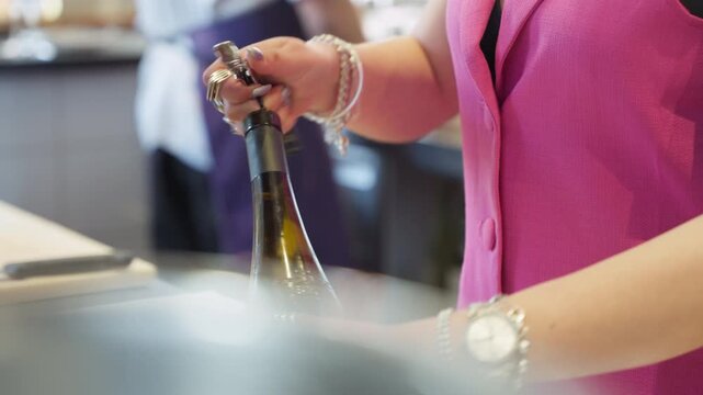 Bartender opening a bottle of wine