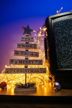 Vintage CRT television, no signal static, glowing lights and festive holiday decorations